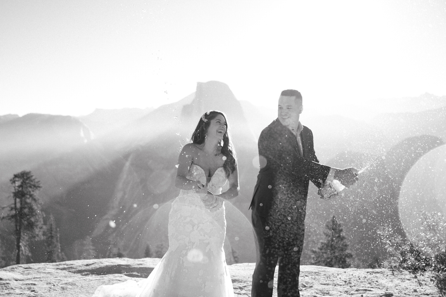 couple spraying champagne at glacier point yosemite